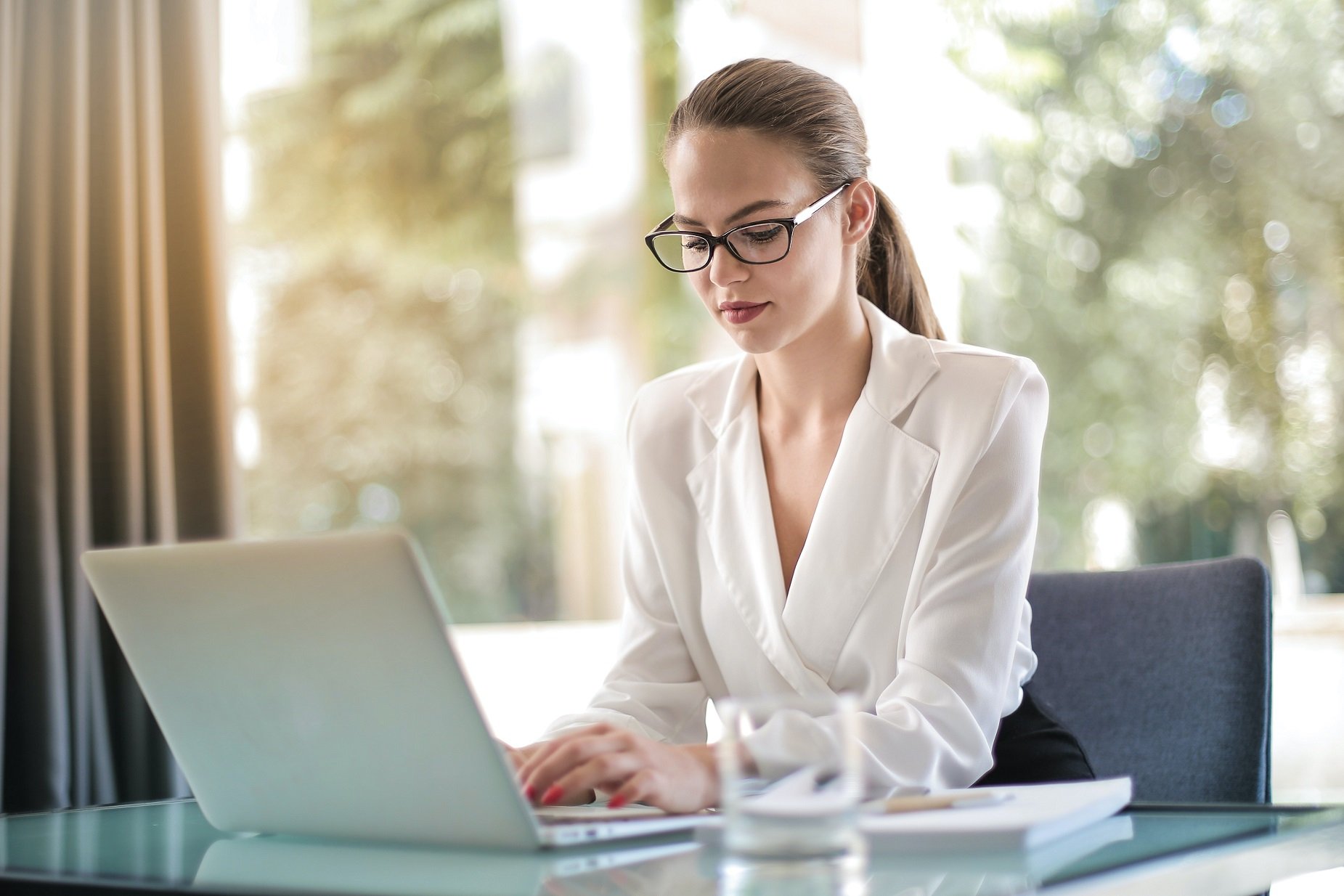 Business Woman Typing On A Laptop